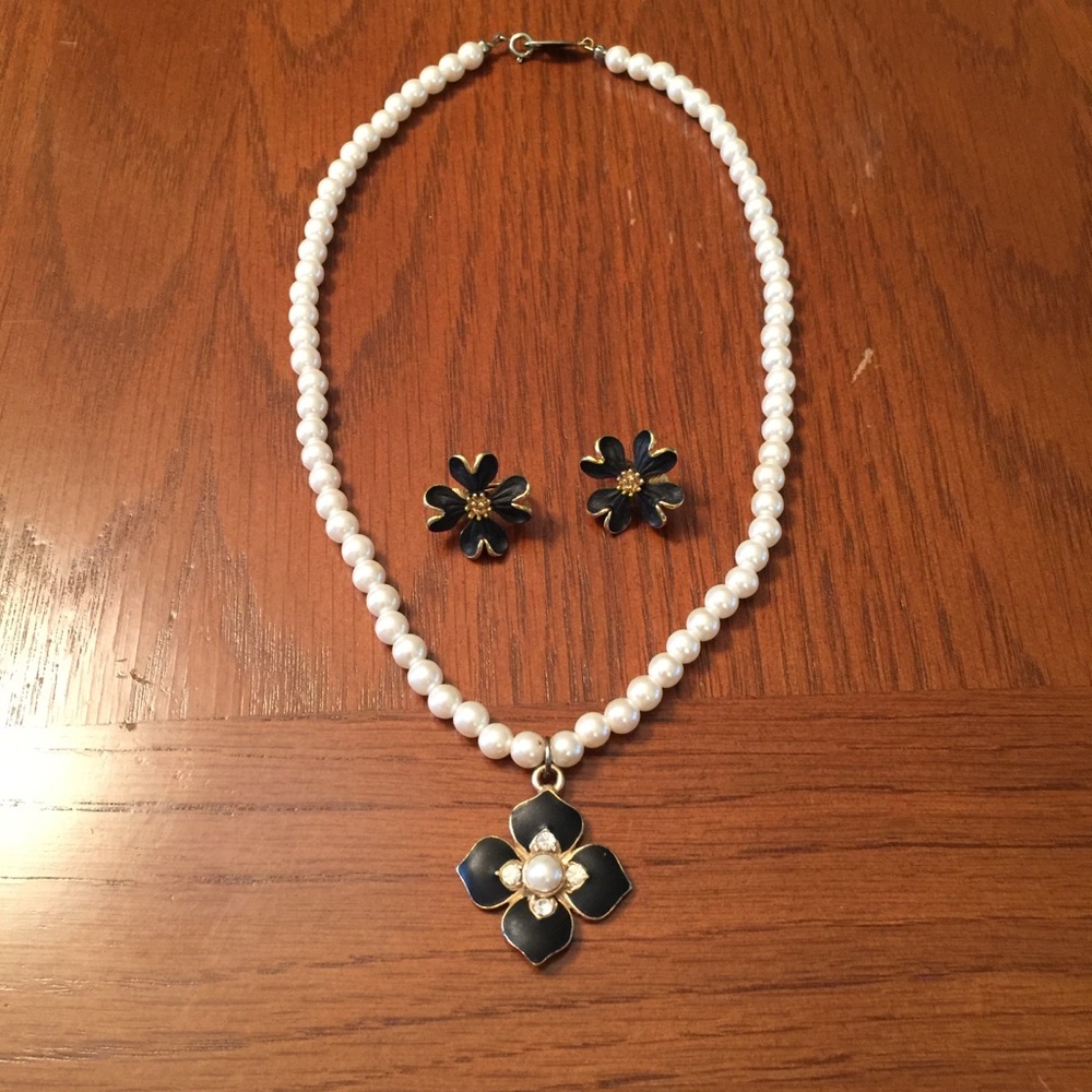 Faux pearl choker and with black flower pendant.